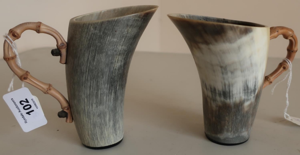 Pair of early-mid 20th C cows horn beakers with shaped bamboo handles