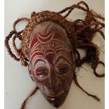 Carved wood African style tribal mask with hessian ropework hair detail (length 33cm)