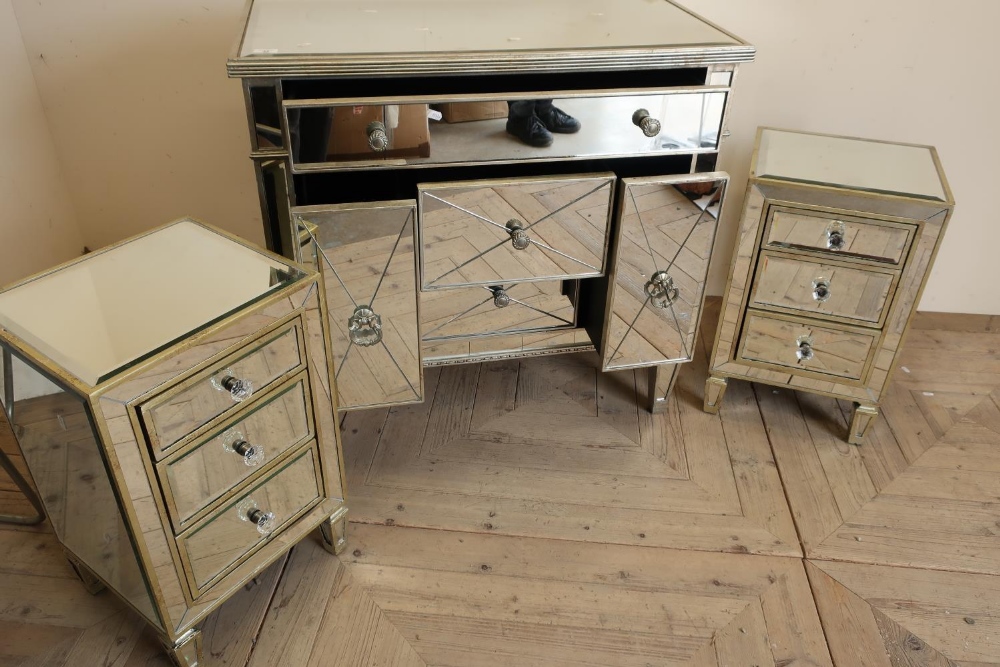 Mirror finished bedroom style chest of one long above of two short drawers flanked by slide out