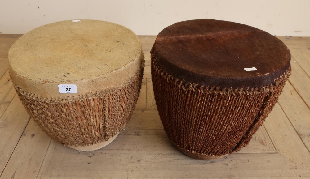 Pair of African style tribal drums finished in animal skin with rope decoration