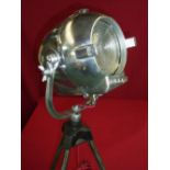 Circa 1960s polished steel stage spotlight mounted on later stand with modern electric wiring,