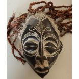 African tribal carved wood mask with hessian stringwork hair