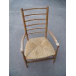 Early 20th C light elm ladder back low rush seated armchair