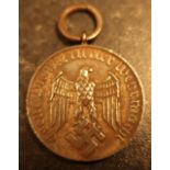 German WWII medal, reverse marked No 4, the front with eagle above swastika