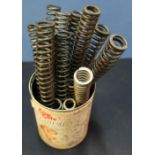 Tin containing a collection of various air rifle mainsprings of various sizes