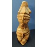 Carved wood African tribal style figure depicting two faces with shell and woven material mounted