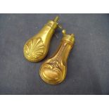 Small pistol powder flask with embossed shell design length 11cm (4 1/4 inch) and another similar (