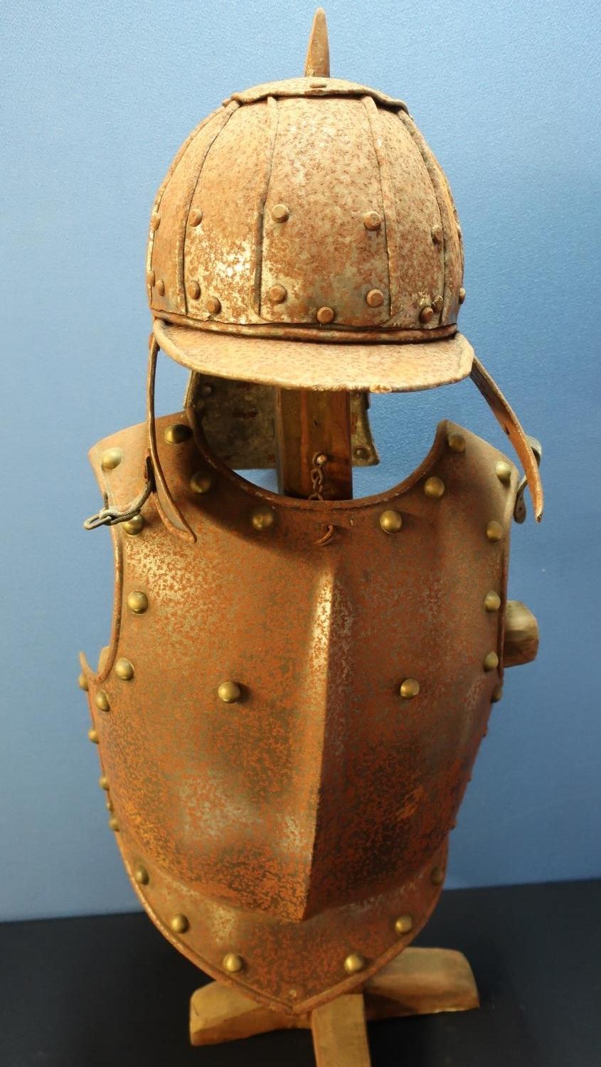 Reproduction steel riveted breast plate and a lobster tail style helmet, with wooden stand