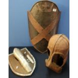 Reproduction steel medieval style crested wall shield, a similar steel helmet with cheek pieces,