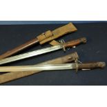 Two British 1907 bayonets complete with scabbards, one with canvas webbing frog, with various