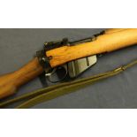 A 1942 Enfield .303 rifle with top covered banded barrel, various stamp marks including 1942, serial