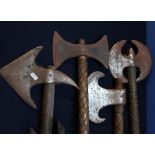 Group of four quality reproduction double handed axes of various forms with wooden shafts, including