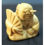 Edo period Japanese Nutsuke of an oriental gentleman with protracting eyes, signed to the base (