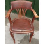 Edwardian oak office style armchair with leatherette seat and H shaped under stretcher