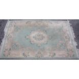 Traditional Chinese embossed washed woollen rug, green ground with central floral medallion and