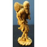 Late 19th C Chinese carved ivory figure of an eldery figure carrying wicker basket upon his