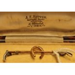 Gents cased gold stock pin in the form of a riding crop & horseshoe stamped 9ct (marks indistinct,