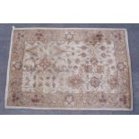 Traditional pattern wool rug, beige ground with stylised floral pattern and border (183cm x 125cm)