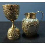 A Birmingham 1892 silver hallmarked cream jug with embossed detail and a continental white metal