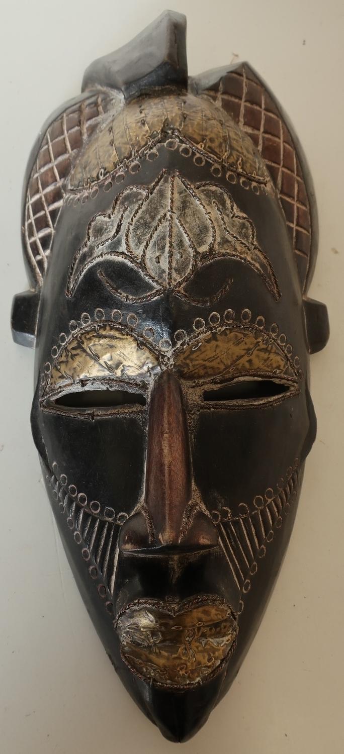 Carved wood African tribal face mask with brass metal mounts
