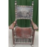 19th/20th C Baronial style carved oak armchair with leather seat and back, and heavy studded detail