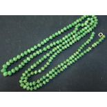 Extremely long 19th/20th C hand knotted green hardstone necklace (overall length 140cm)