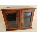 Edwardian oak table/smokers cabinet with hinged lift up top and two bevelled edge glass panel