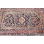 20th C Middle Eastern rug rust and blue ground, central medallion and stylized floral pattern border