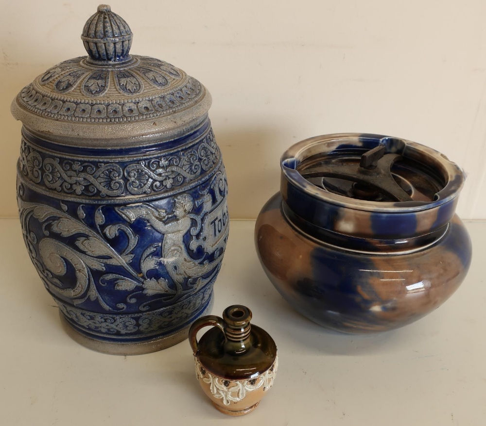 A stoneware metal glazed tobacco jar, a small Doulton Lambeth stoneware jug and a late 19th C salt