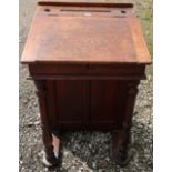 Late Victorian stained pine schoolmaster's desk with lift up top, turned columns and cupboard (