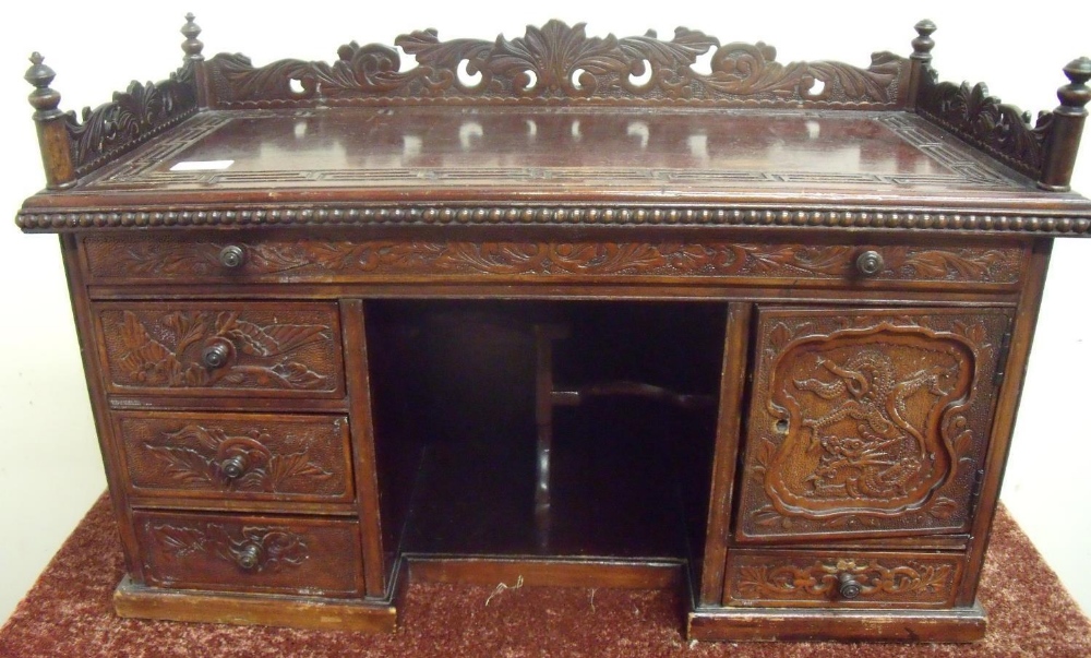 19th/20th C mahogany Oriental style table desk, the raised back and sides with carved fretwork