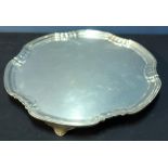 A large Sheffield 1930 silver hallmarked salver on 3 raised supports, with stepped edge border (