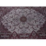 Traditional pattern, fawn and red ground rug with central medallion surrounded by scrolling acanthus