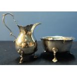 A Birmingham 1900 silver hallmarked cream jug and a London 1899 silver hallmarked sugar bowl on