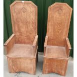 Pair of modern Medieval style Baronial throne type chairs with carved shield crest detail to the