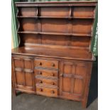 Ercol dining suite comprising of dresser with two tier raised back, four central drawers and two