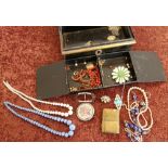 Japped metal cash box containing a selection of various assorted costume jewellery