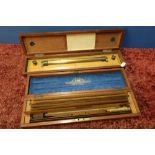 Cased boxwood and brass rule device marked Coombes Devonport, and a cased set of various boxwood,