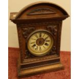 Wooden carved chiming mantel clock with enamel and brass dial, movement stamped with two crossed