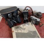 Minolta AL camera, another vintage folding camera, binoculars and a photograph album depicting