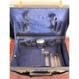 Blue leather travelling case with outer cover and fitted interior containing six silver hallmarked