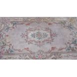 Chinese embossed washed woollen rug, beige ground with floral central medallion and patterned border