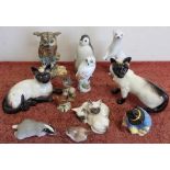 Selection of various decorative figures of animals including Royal Doulton cats, Beswick Siamese