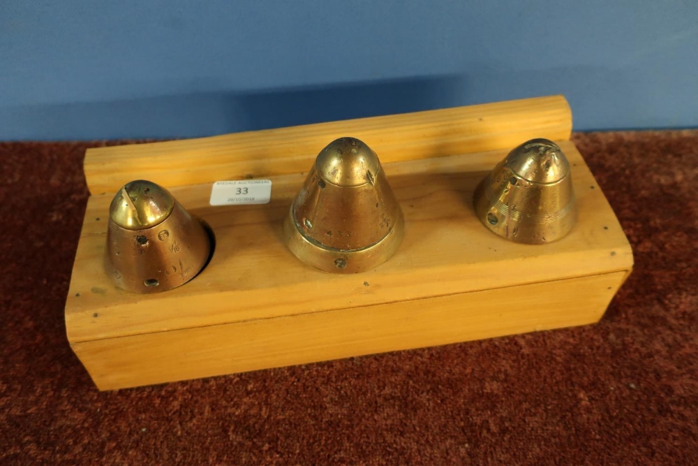 Three WWI mounted fuse nose cones