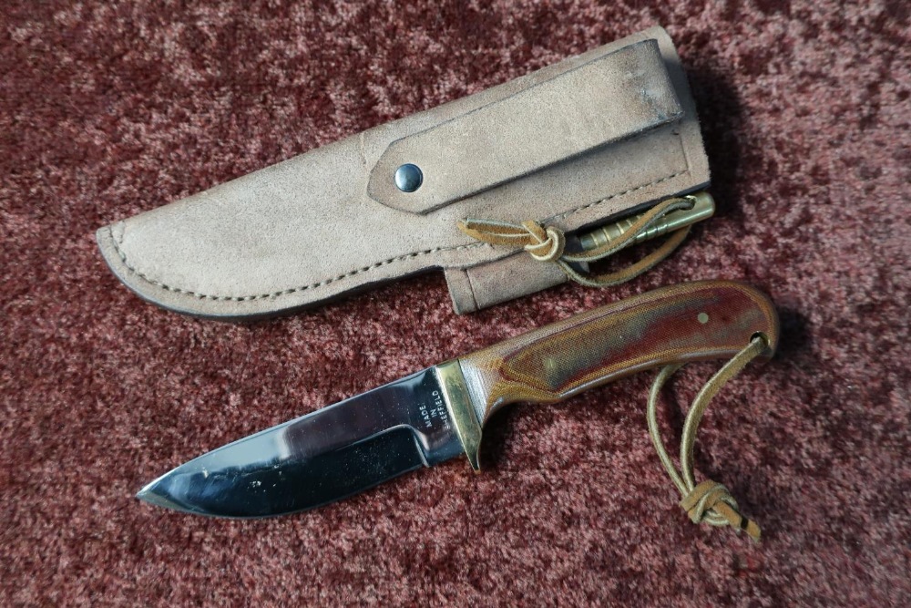 Sheffield made sheath knife with 4 inch blade, brass crosspiece and two piece grips, complete with