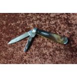 A vintage twin bladed pocket knife with two piece horn grips by William Rogers Sheffield