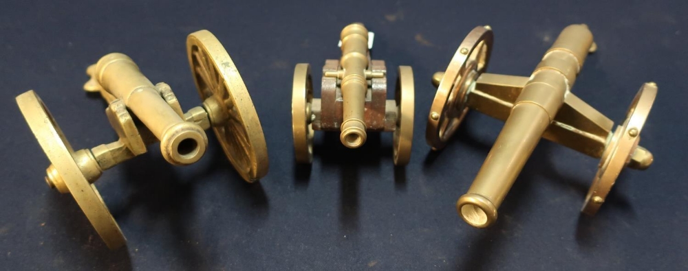 Group of three brass model cannons of various design