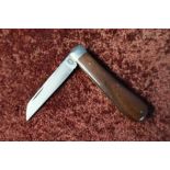 Single bladed pocket knife with two piece wooden grips