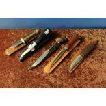 Group of five sheath knives with leather sheaths including small Damascus bladed knife, a Buck USA