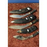 Three Kukri knives of various size with lions head pommels and leather sheaths